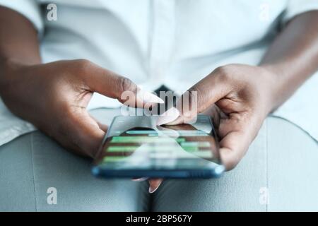 Black Woman Using Mobile Phone For Text Messaging Stock Photo