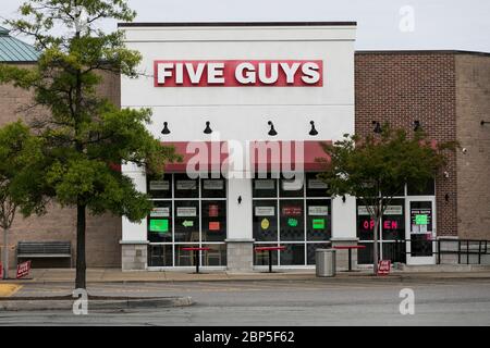 A logo sign outside of a Five Guys restaurant location in Richmond, Virginia on May 13, 2020. Stock Photo