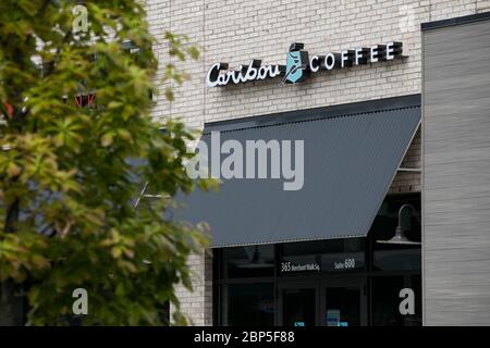 A logo sign outside of a Caribou Coffee Company location in Charlottesville, Virginia on May 13, 2020. Stock Photo