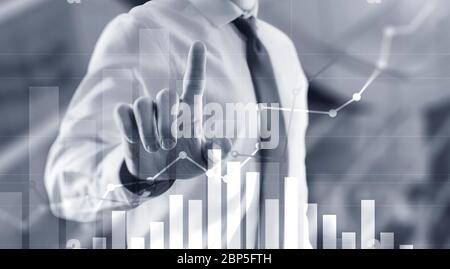 Businessman drawing graph with marker on media screen. Stock Photo