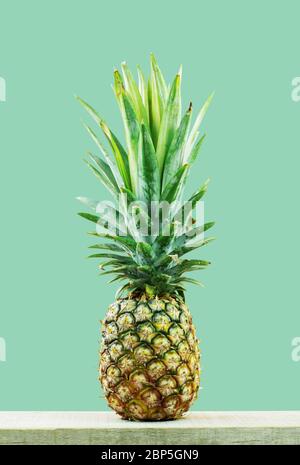 Pineapple on wood with the green background. Stock Photo