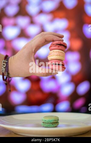 Colorful macarons on black background, close up view Stock Photo