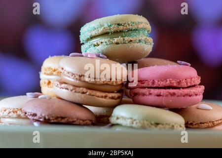 Colorful macarons on black background, close up view Stock Photo