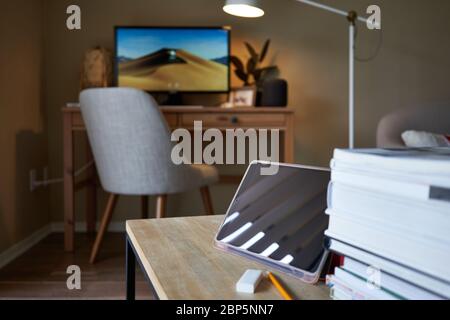 Tablet computer on the table with selective focus on the tablet camera. Online class and video conferencing at home. Stock Photo