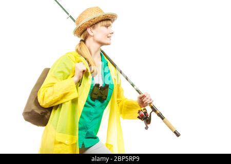 Fishery, spinning equipment, angling sport and activity concept. Woman wearing raincoat holding fishing rod, ready for adventure. Stock Photo