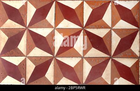 Old porcelain tiles floor texture with tiles of dark brown, light brown and beige colors Stock Photo