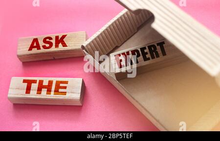 Ask the Expert words on wooden blocks. laying in box and outside. Consulting a professional for advice business concept