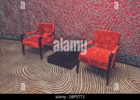Luxury vintage red armchair on red background Stock Photo