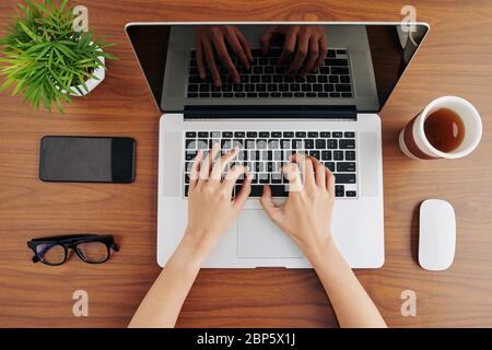 Close-up image of software developer programming on laptop when working from home Stock Photo