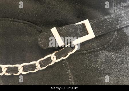 image background bootleg of a leather boot with a yellow buckle and chain Stock Photo