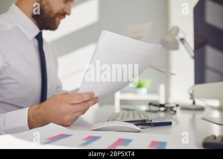 Office work is faceless. Businessman works at a table with a computer in the office. Stock Photo