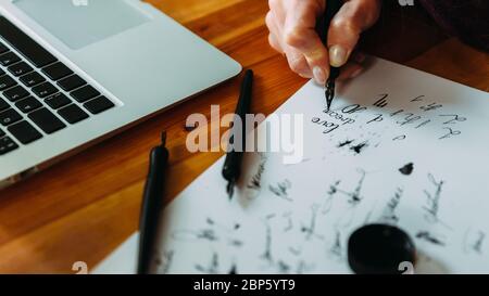 Unrecognizable girl trains in calligraphy and lettering, close-up Stock Photo