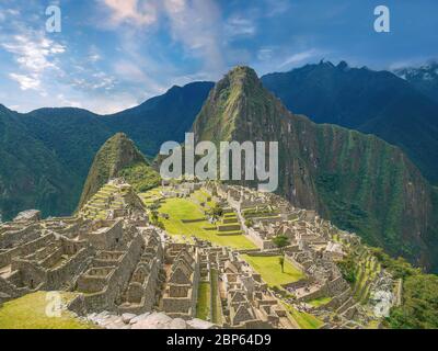 The iconic Machu Picchu stone ruins and Huayna Picchu mountain in vibrant color and light. Peru. Stock Photo