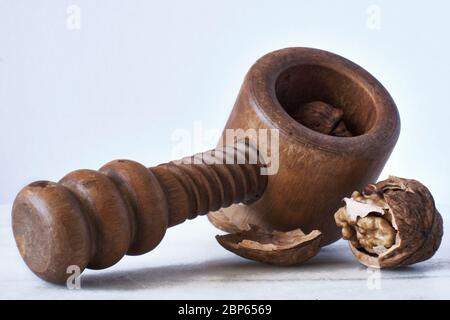 Walnuts and Wooden Nutcracker on a white background Stock Photo