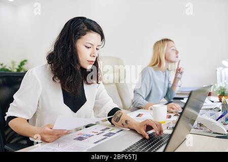 Serious UI designer working on interface for new mobile application Stock Photo