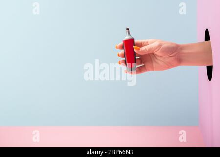 Woman's hand holding a red felt-tip pen marker Stock Photo
