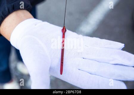 Checking car's oil dipstick on a white glove. Close up image of vehicle's oil level. Stock Photo