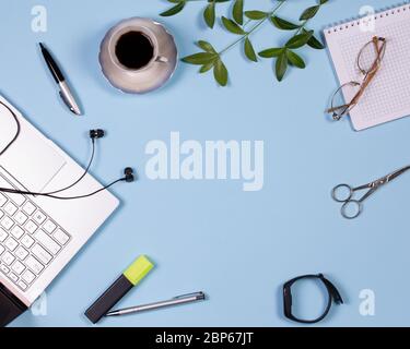 Workspace with pens, a laptop, headphones, a notebook and a cup of coffee Stock Photo