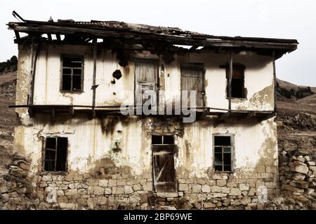 Dying mountain villages (aul) in the Caucasus. Dilapidated houses in winter. Poor farms Stock Photo