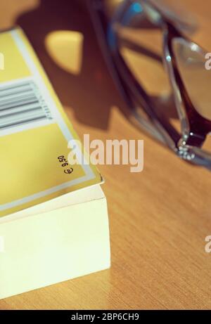 book and glasses on table Stock Photo