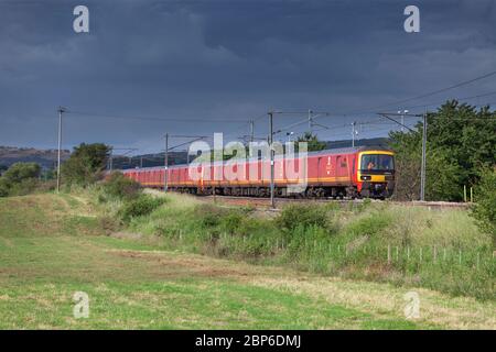 3 Royal Mail Class 325 postal trains pass Millhead  (north of Carnforth) on the west coast mainline in Lancashire with a mail train Stock Photo