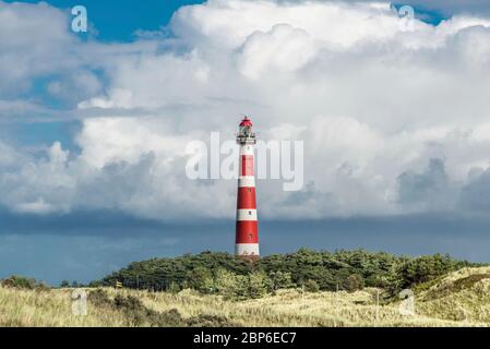 Dune path on the North Sea island of Ameland with a view of the lighthouse Stock Photo