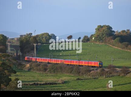 3 Royal Mail Class 325 postal trains pass Milnthorpe  (north of Carnforth) on the scenic west coast mainline in Cumbria with a mail train Stock Photo