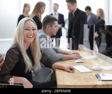 smiling young woman at the workplace, in the office Stock Photo