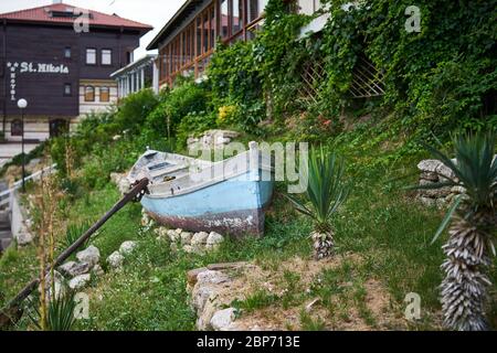 NESSEBAR, BULGARIA - JUNE 22, 2019: Old wooden boat as decoration on the streets of the seaside town. Stock Photo
