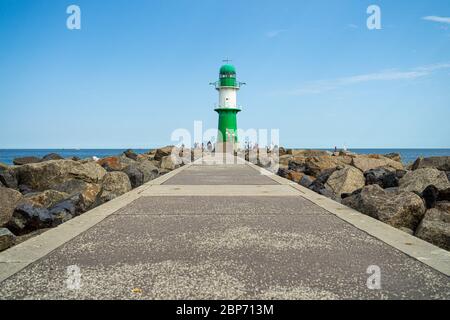 WARNEMUENDE (ROSTOCK), GERMANY - JULY 25, 2019: Lighthouse in front of the entrance to the waters of the sea port of Rostock - Warnemuende. Stock Photo