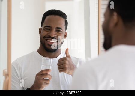 Smiling biracial man recommend clean water drinking Stock Photo