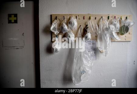 Berlin, Germany. 18th May, 2020. Masks hang in front of the entrance to the treatment room at the Kältehilfe Emergency Overnight Stay, an all-day shelter for homeless people. Credit: Britta Pedersen/dpa-Zentralbild/ZB/dpa/Alamy Live News Stock Photo