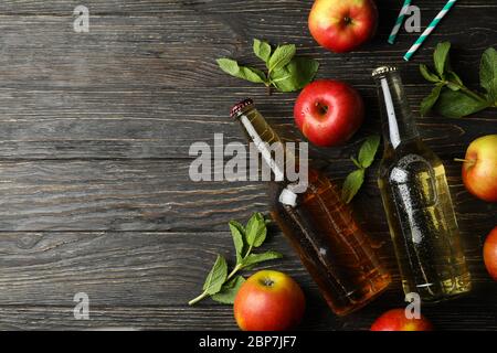 Composition with cider, apples and straws on wooden background Stock Photo