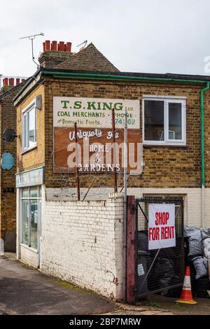 T S King coal merchants in Herne Bay. Painted wall signs show how things have changed. Kent, UK Stock Photo