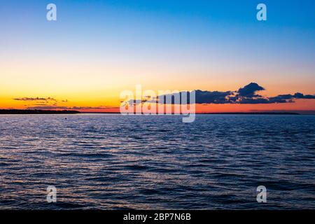 A beautiful deep red and orange sunset over the Swale and Thames Estuary viewed from Hampton, Herne Bay, Kent, UK Stock Photo