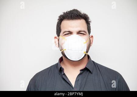 Man covering his face with covid-19 mask, safe working environment Stock Photo