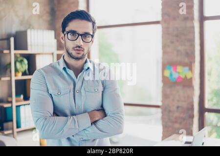 Successful young handsome middle eastern man lawyer in a formal outfit and glasses with crossed hands. Severe and harsh, rich and confident, attractiv Stock Photo