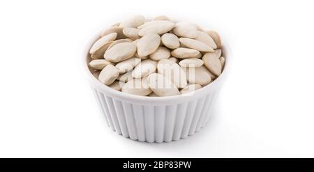 Pumpkin seeds in bowl isolated on white background Stock Photo