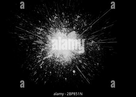 Freeze motion of white powder exploding, isolated on black, dark background. Abstract design of white dust cloud. Particles explosion screen saver, wa Stock Photo