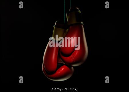 Boxers red gloves.. Professional sport equipment isolated on black studio background. Concept of sport, leadership, competition, healthy lifestyle in motion and action, training. Close up, copyspace. Stock Photo