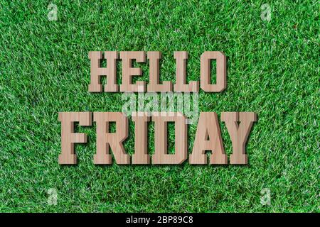 Hello friday made from wooden alphabet on green grass. Stock Photo