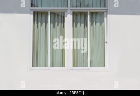 modern windows with light protection curtain on white wall. outside of a apartment Stock Photo