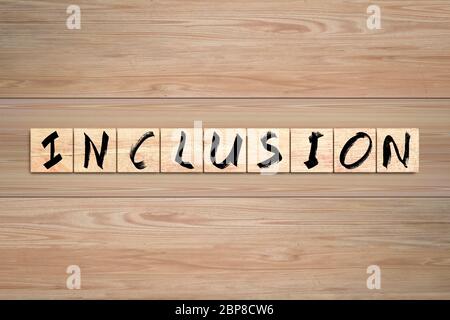 Inclusion word written on wood box. Text on wooden table. Stock Photo