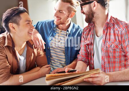 Smiling guys having friendly conversation Stock Photo