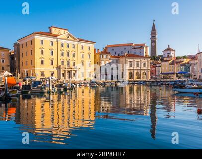 Venetian Port and The Main Square Tartini of Piran City Reflected on Water in Slovenia. Stock Photo