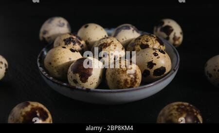 still life, quail eggs on a plate on a dark background, close-up Stock Photo
