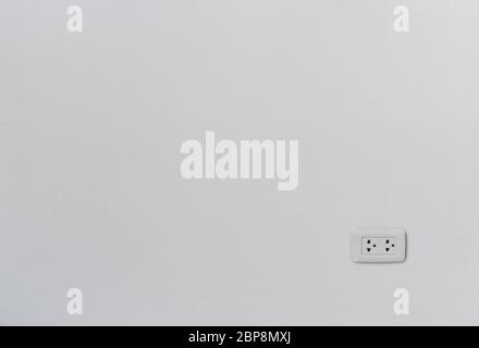 Modern thailand power outlet on white plaster wall with copy space Stock Photo