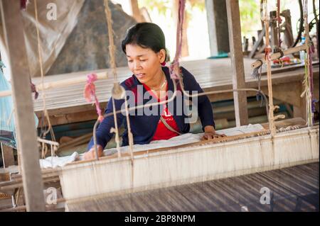 Woman weaving silk on a traditional weaving frame. Silk Island, Phnom Penh, Cambodia, Southeast Asia Stock Photo