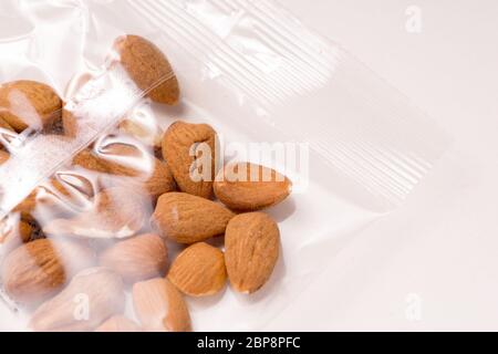 almonds packages in plastic packaging isoalted on white background Stock Photo