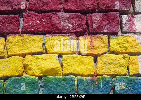 Detail of colored brickwall in red, yellow and blue. Stock Photo